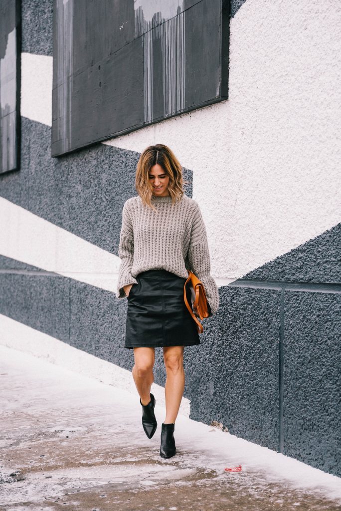 Blogger Mary Krosnjar wearing faux leather skirt and marc fisher booties
