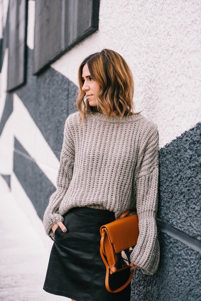 Blogger Mary Krosnjar wearing Grey Bell Sleeve Oversized Sweater and faux leather skirt