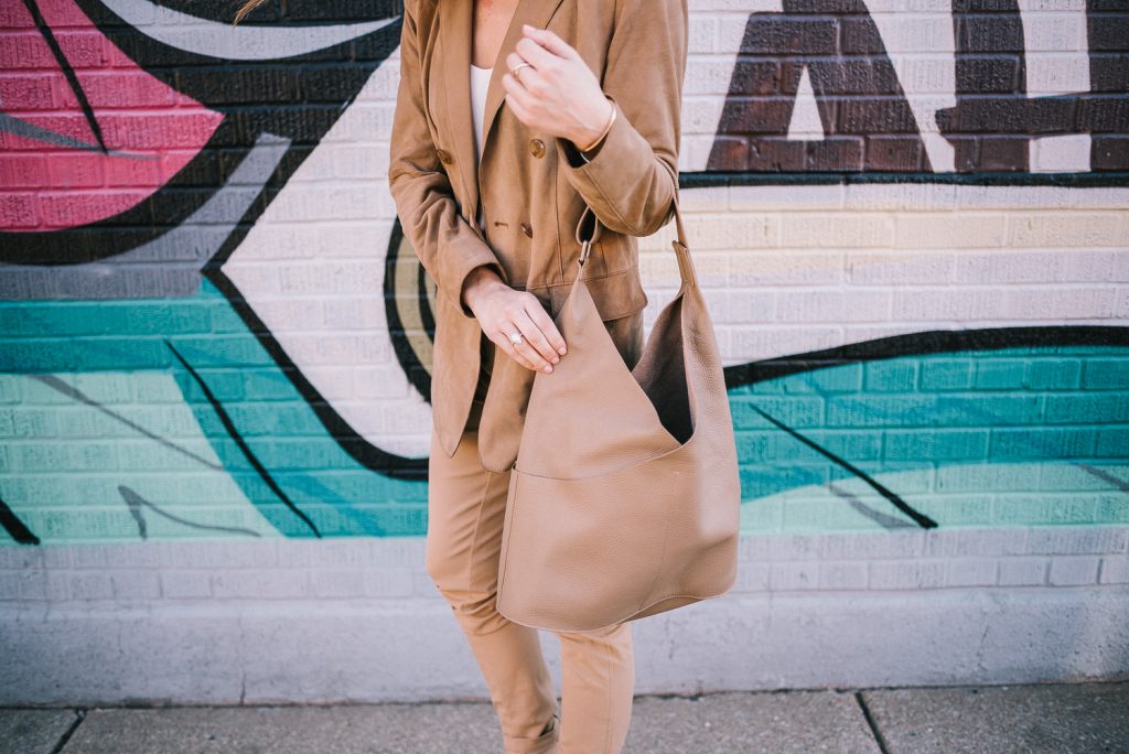 Blogger Mary Krosnjar wearing suede large tote and Pantsuit Nation