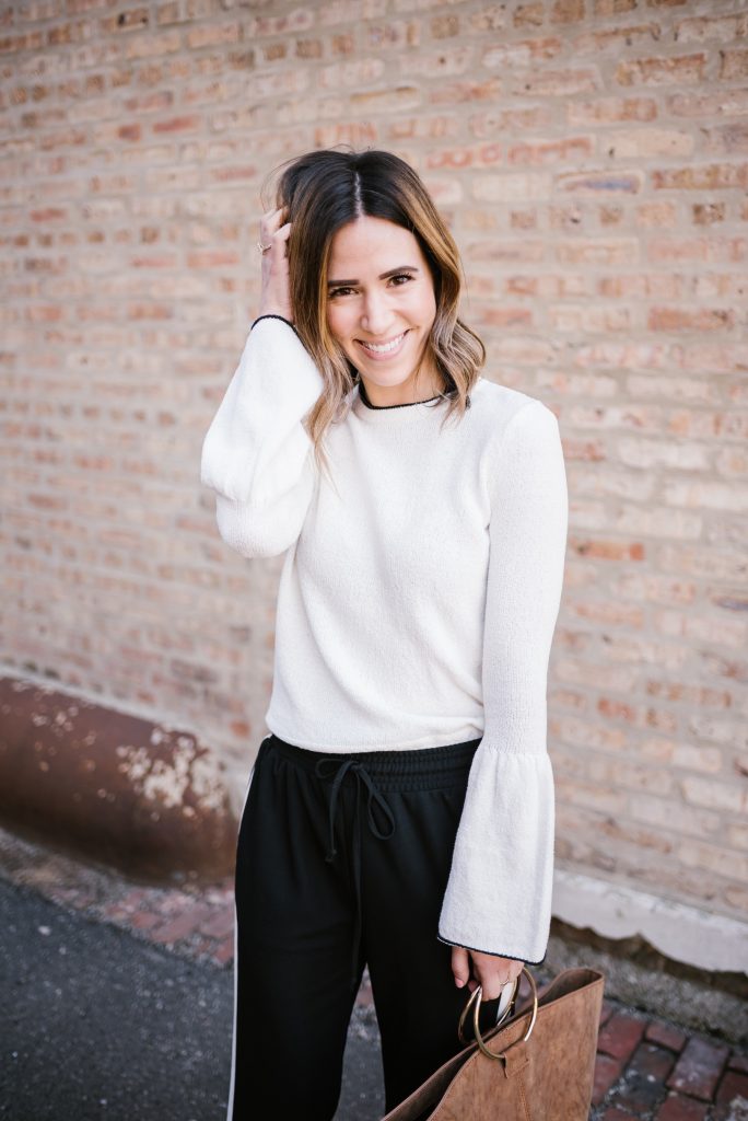 Blogger Mary Krosnjar wearing Who What Wear Bell Sleeve top and Track Pants