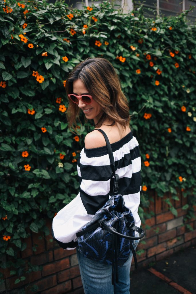 Blogger Mary Krosnjar wearing MLM Label Off the Shoulder Top and Opening Ceremony Printed Backpack 