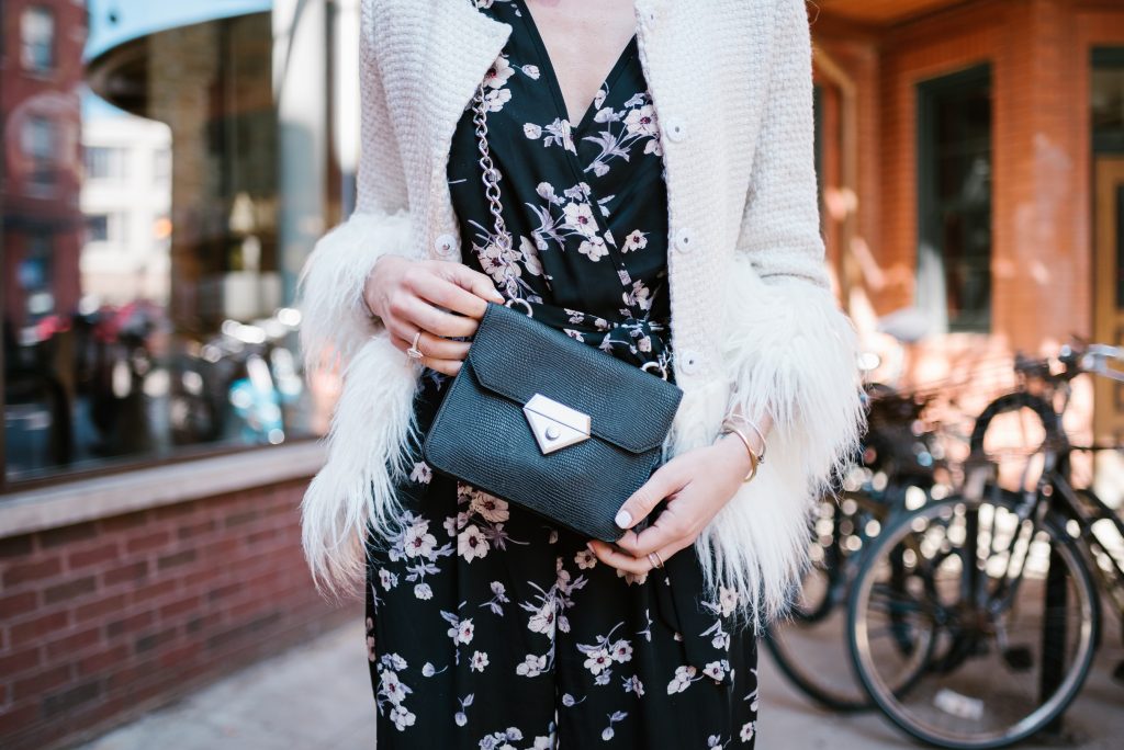 Blogger Mary Krosnjar wearing Linea Pelle Black Crossbody and white blazer with faux fur trim 