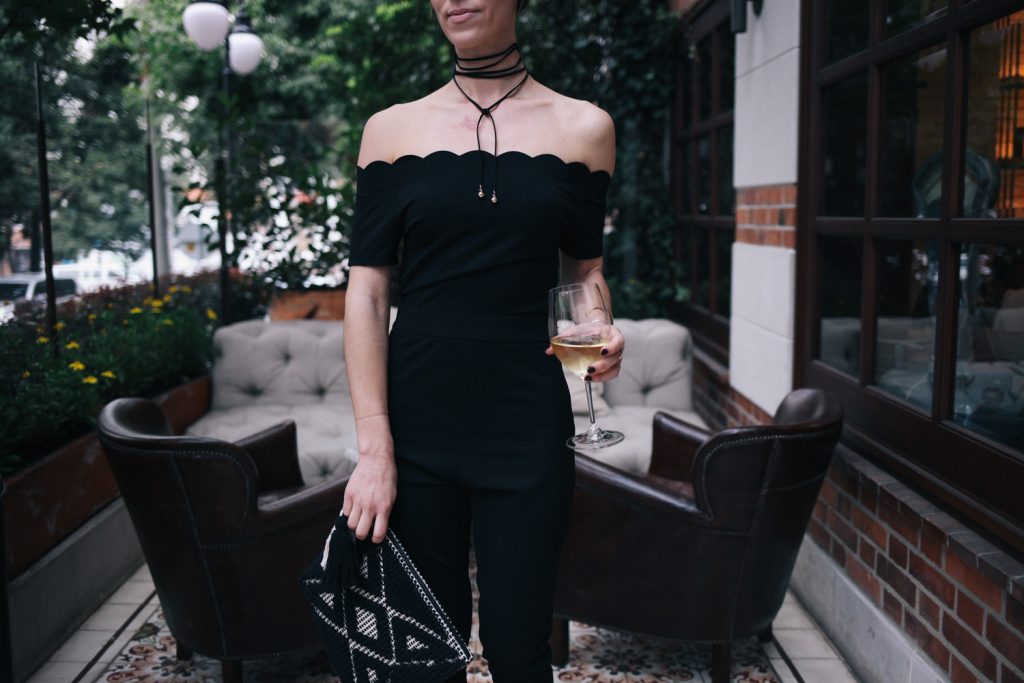 Blogger Mary Krosnjar wearing scalloped jumpsuit from Shein and Sole Society tasseled woven clutch