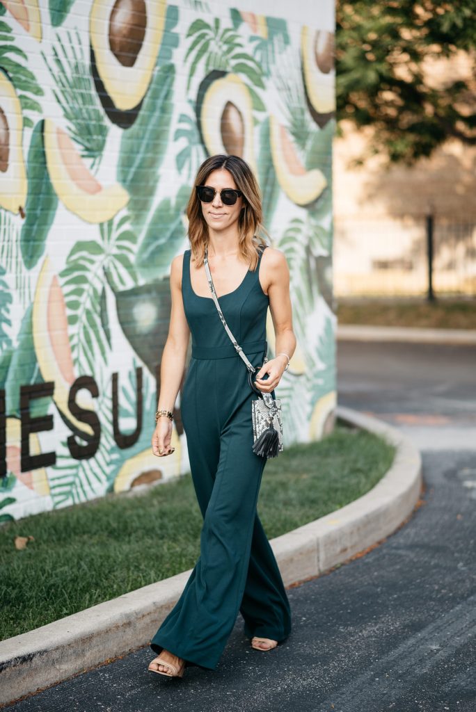 Blogger Mary Krosnjar wearing Donna Morgan Sweetheart Neck Jumpsuit at the Avocado wall in Chicago 