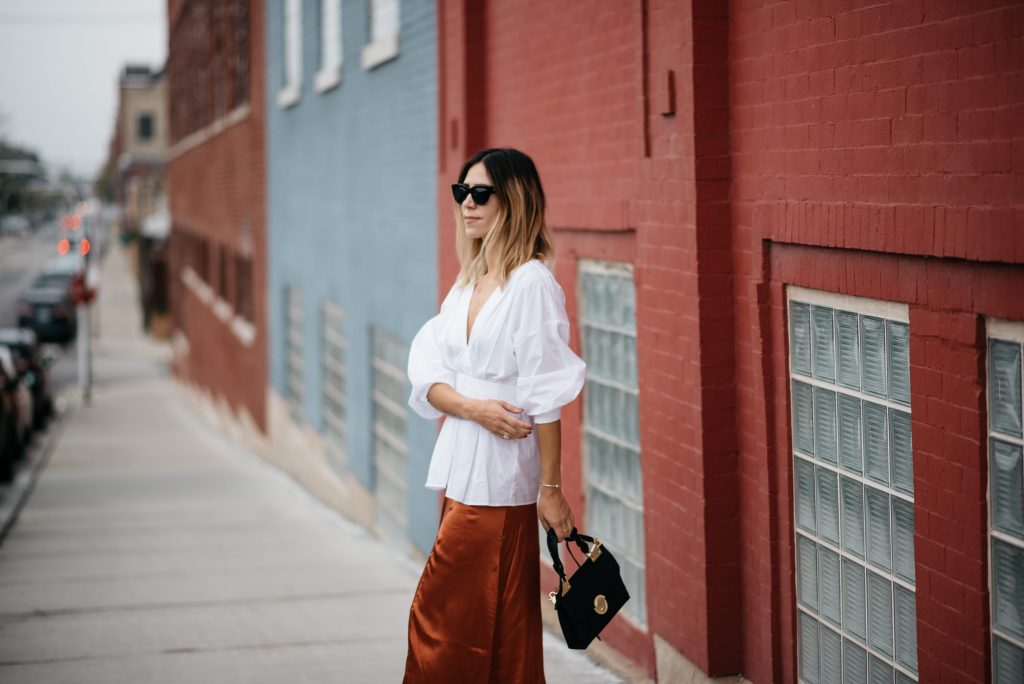 Blogger Mary Krosnjar wearing H&M Rust Satin Skirt and white oversized blouse