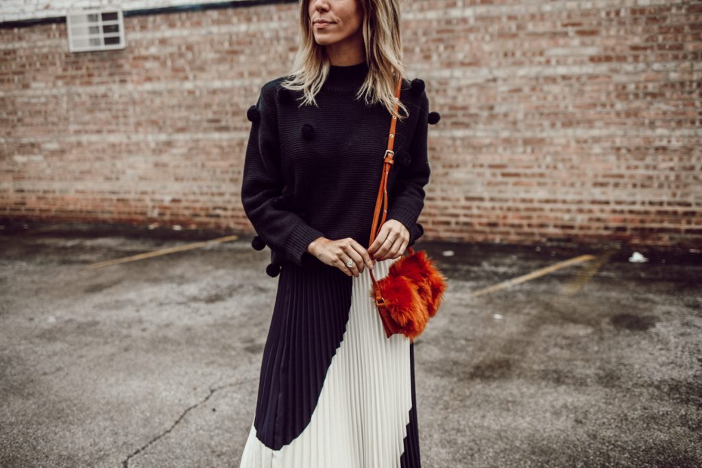 BLogger Mary Krosnjar wearing Rachel Parcell Black Pom Pom Sweater and H&M pleated skirt