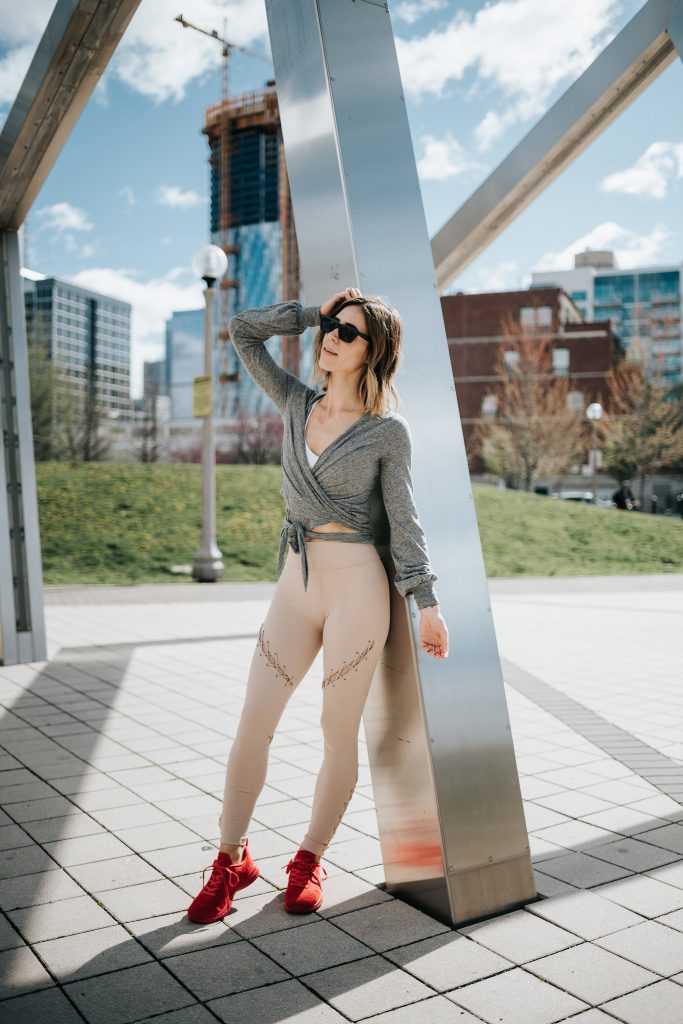 Blogger Mary Krosnjar wearing APL sneakers and Ballet wrap long sleeve top