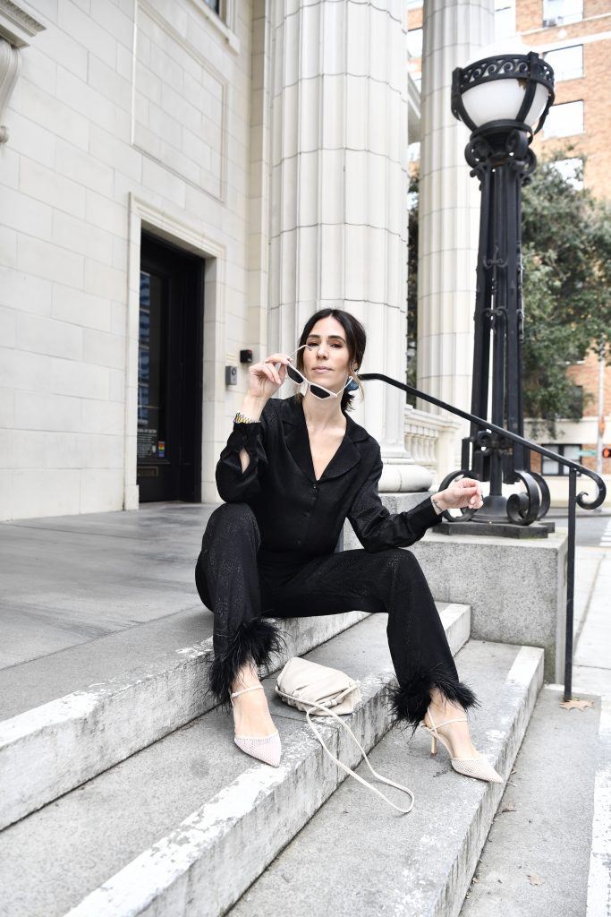 Blogger Sportsanista wearing black silk blouse, black silk pants with ostrich feather trim and mesh nude pumps