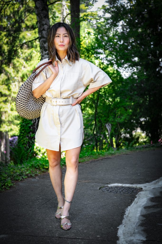 Blogger E for Elisa wearing utility summer dress and gold sandals 