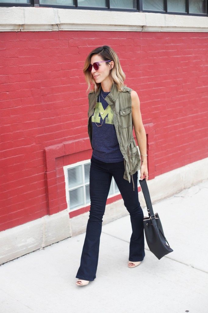 House of Holland Cagefighter sunglasses, Black bucket bag, University of Michigan Muscle Tee, Game day fashion, game day fashion ideas, what to wear to a football game, Olive khaki Vest, Nude open-toe mules, Henry & Bell Micro Flare Denim, University of Michigan, Michigan Wolverines
