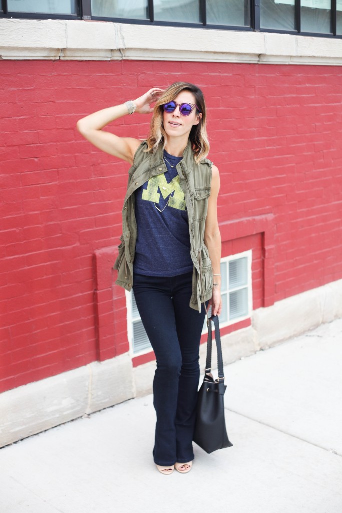 House of Holland Cagefighter sunglasses, Black bucket bag, University of Michigan Muscle Tee, Game day fashion, game day fashion ideas, what to wear to a football game, Olive khaki Vest, Nude open-toe mules, Henry & Bell Micro Flare Denim, University of Michigan, Michigan Wolverines