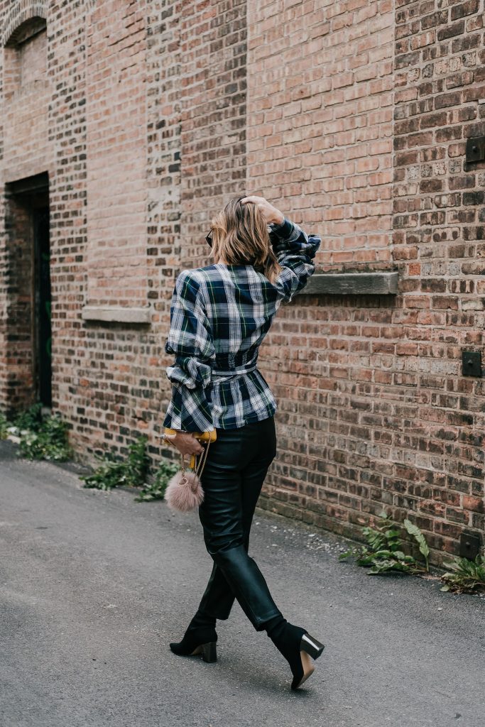 Blogger Mary Krosnjar wearing Petersyn Puff Sleeve Wrap Top and H&M Faux Leather Pants