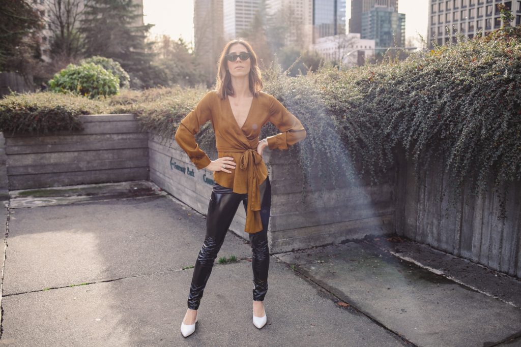 Blogger Sportsanista wearing Anthropologie Brynn Tie-Front Blouse and H&M Patent Treggings