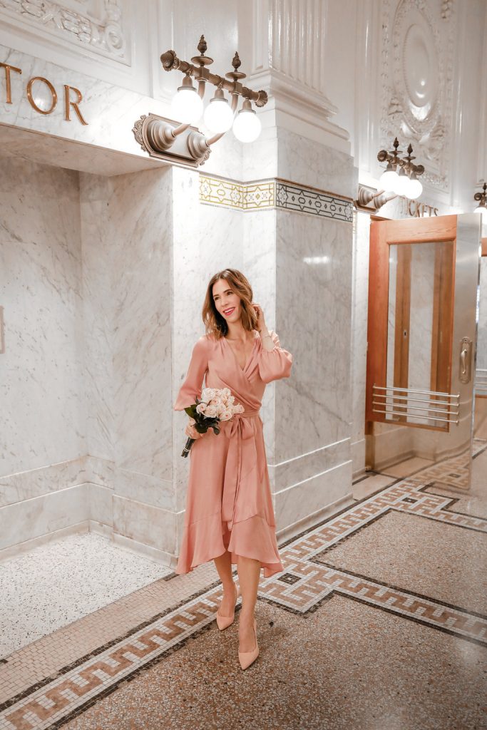 Blogger Sportsanista wearing pink silk wrap dress and pink suede pointy toe pumps