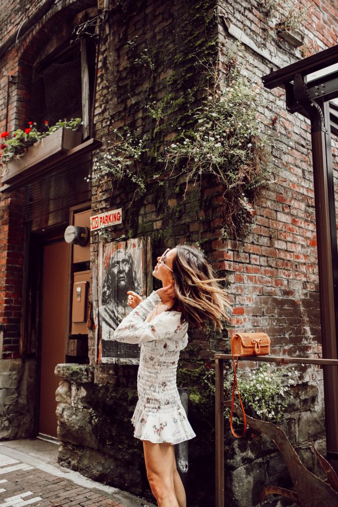 Seattle Fashion Blogger Sportsanista wearing white floral smocked dress in Pioneer Square, Seattle