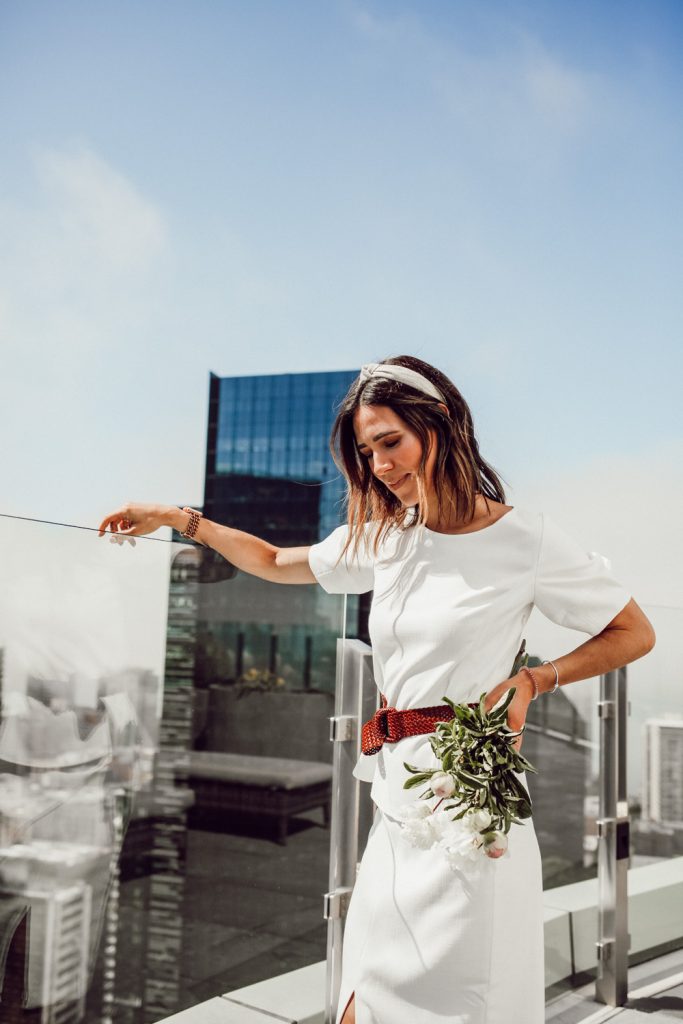 Seattle Fashion Blogger Sportsanista on Seattle Rooftop wearing White blouse and Woven belt for work