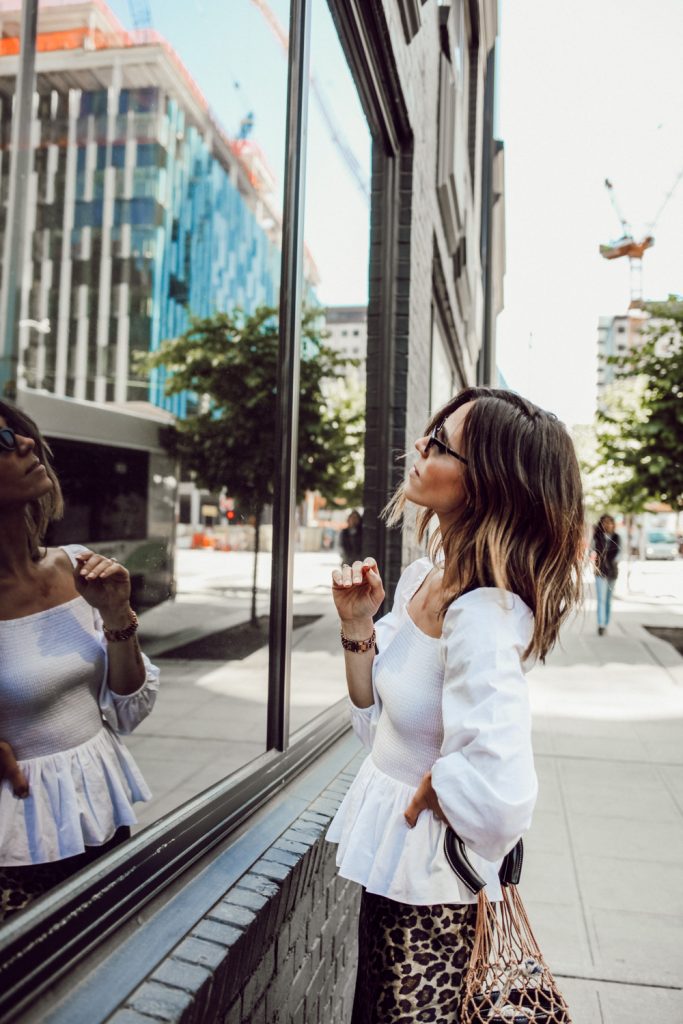 Seattle Fashion Blogger Sportsanista wearing smocked white top in South Lake Union 