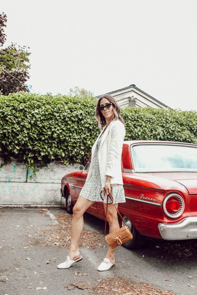 Seattle Fashion Blogger styling a white oversized blazer, floral dress and wicker bag for summer